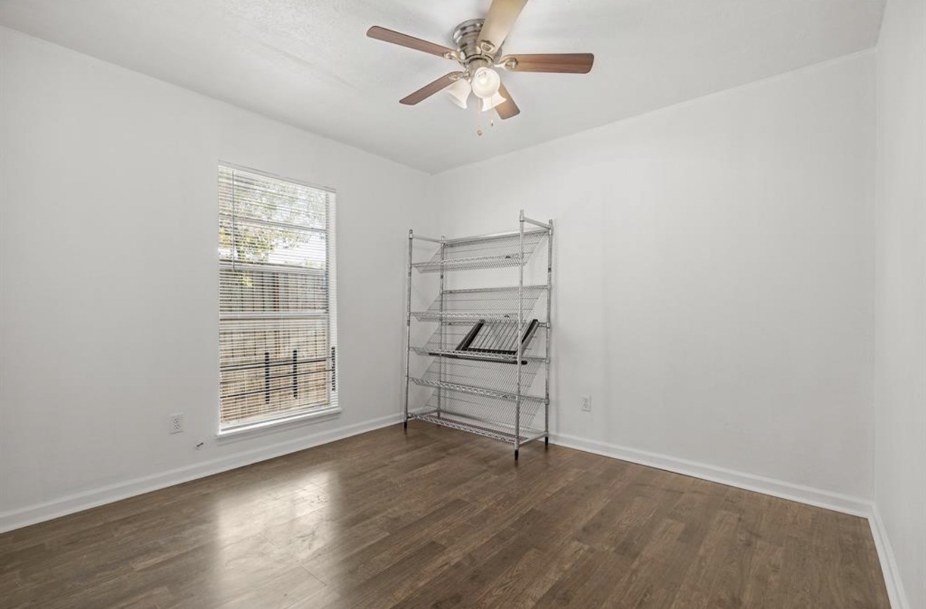 402 Paschall Street Houston, TX 77009 - Photo 8 of 11 wooden floor in an empty room with a window