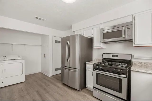 a kitchen with stainless steel appliances white cabinets and stainless steel appliances