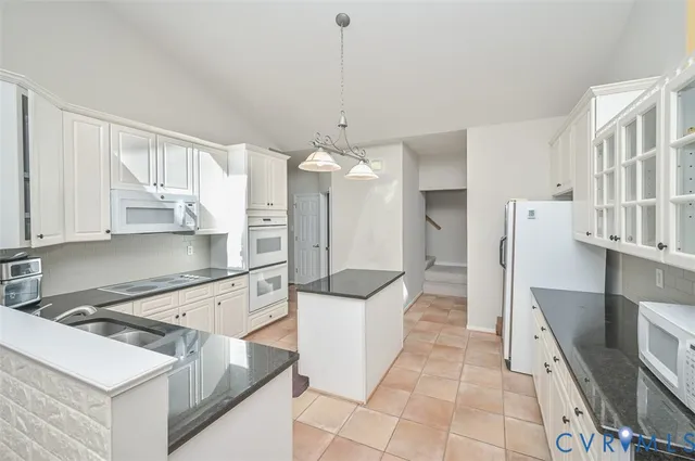 a large white kitchen with a large window