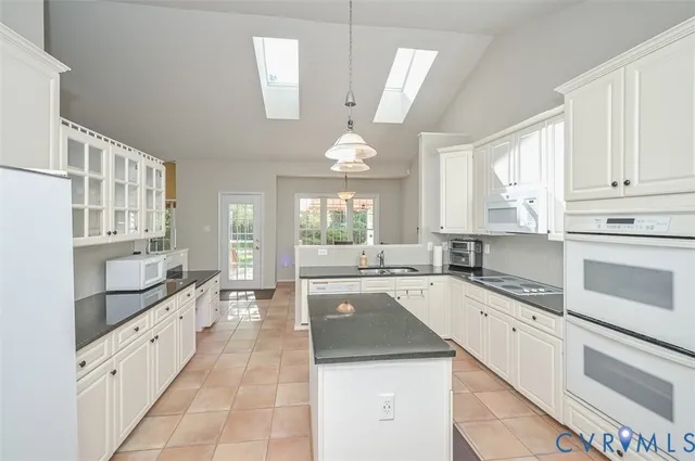a kitchen with a stove sink and cabinets