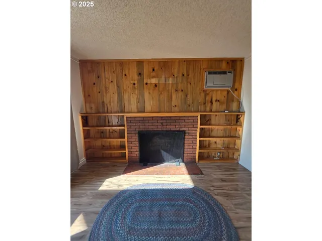 a living room with a fireplace and a rug