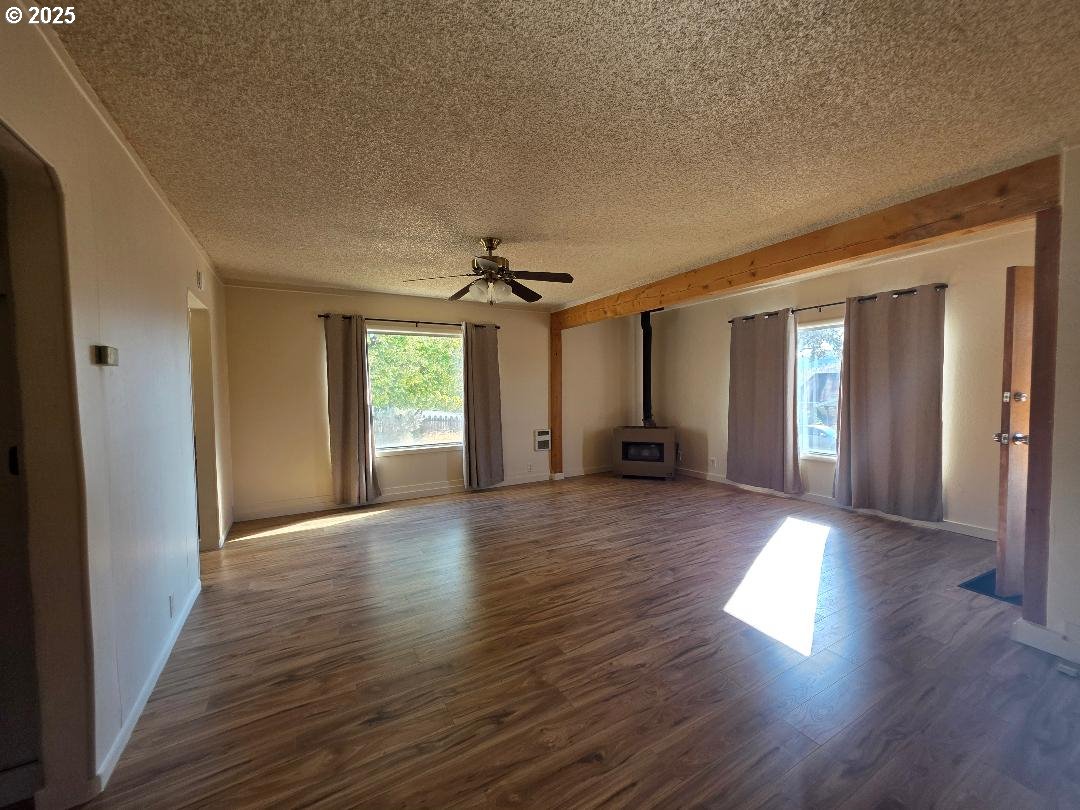 614 Staats Avenue Maupin, OR 97037 - Photo 14 of 39 a view of a big room with wooden floor and windows