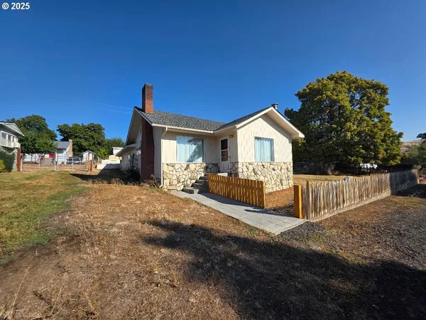 a view of house with yard and entertaining space