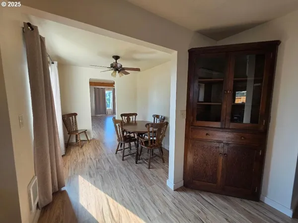 a view of a dining room with furniture and a ceiling fan