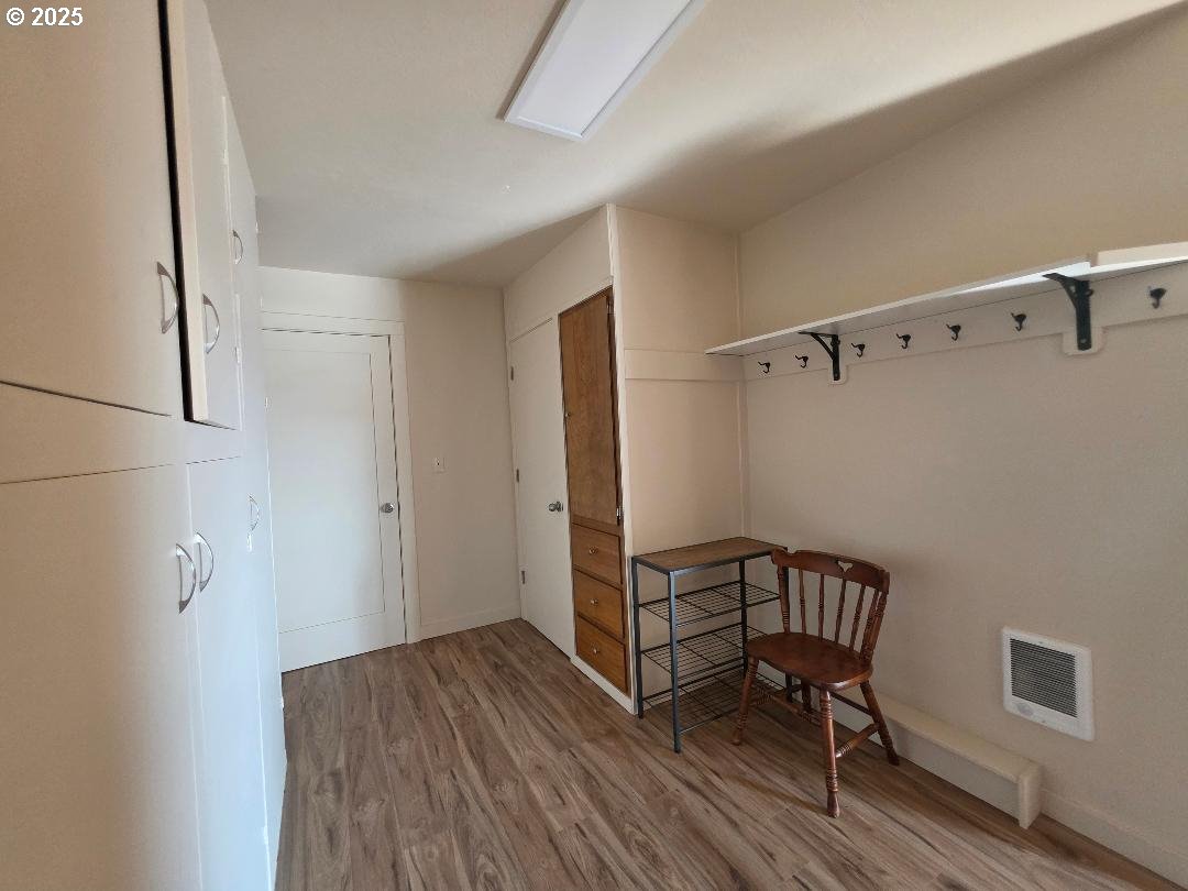 614 Staats Avenue Maupin, OR 97037 - Photo 31 of 39 a view of a hallway with wooden floor and a cabinet