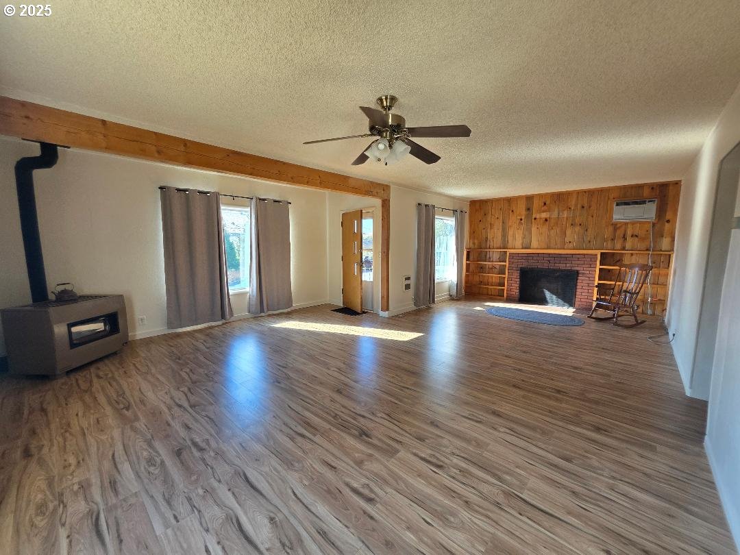 614 Staats Avenue Maupin, OR 97037 - Photo 9 of 39 a view of a livingroom with wooden floor and a fireplace
