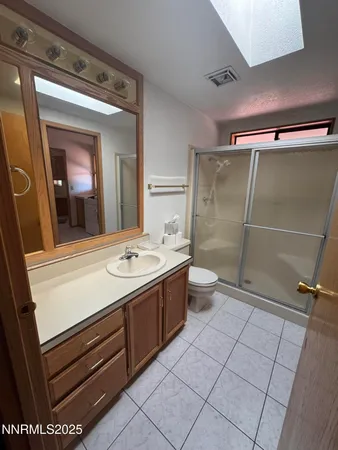 a bathroom with a shower and a vanity