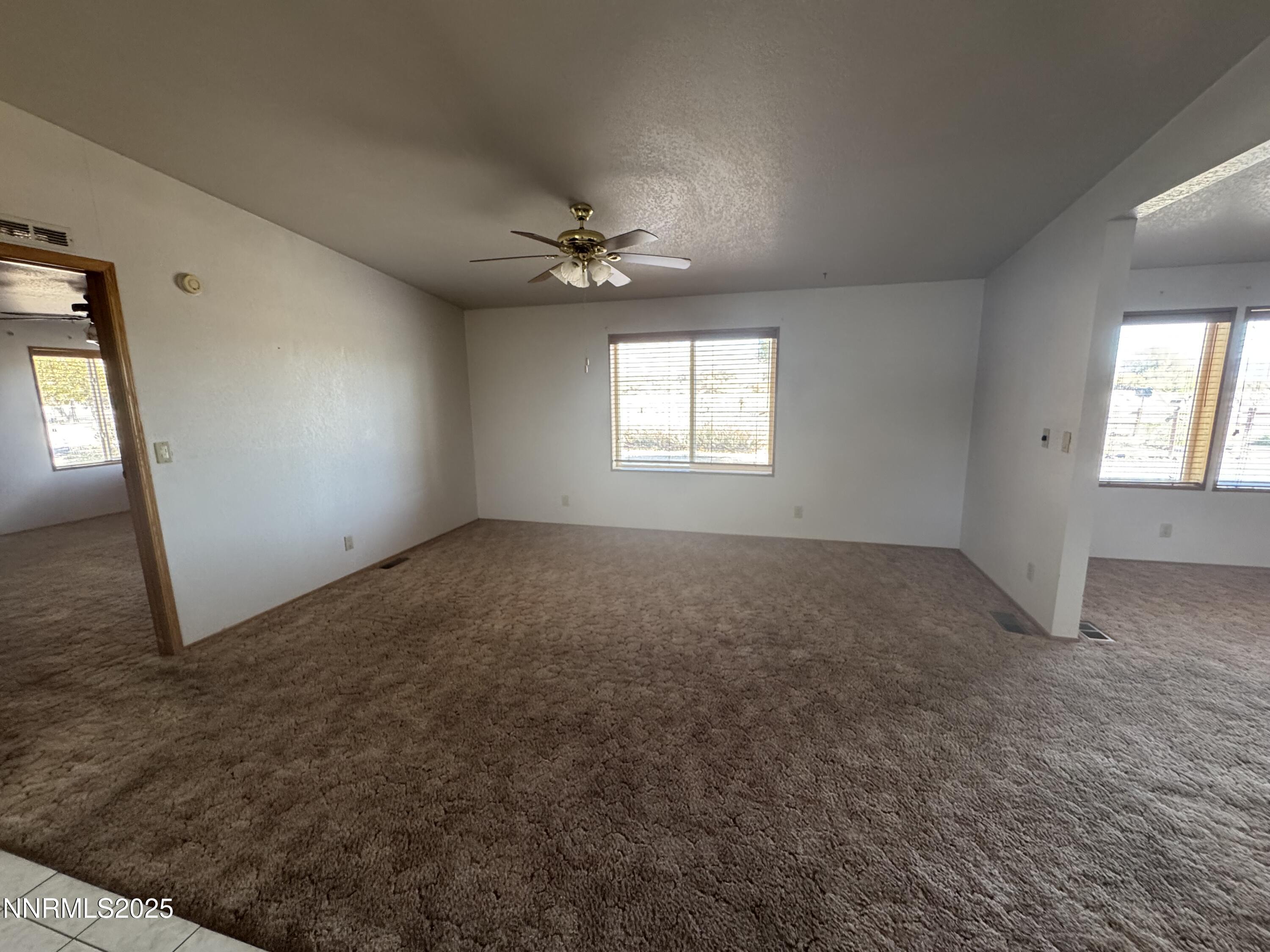 3255 Upper Valley Road Lovelock, NV 89419 - Photo 6 of 28 an empty room with windows and ceiling fan view