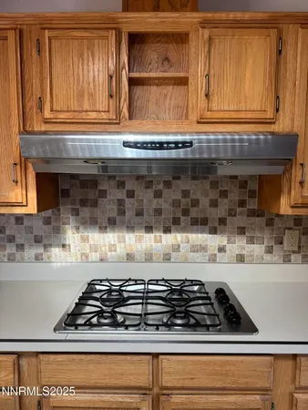 a kitchen with stainless steel appliances granite countertop a sink and cabinets