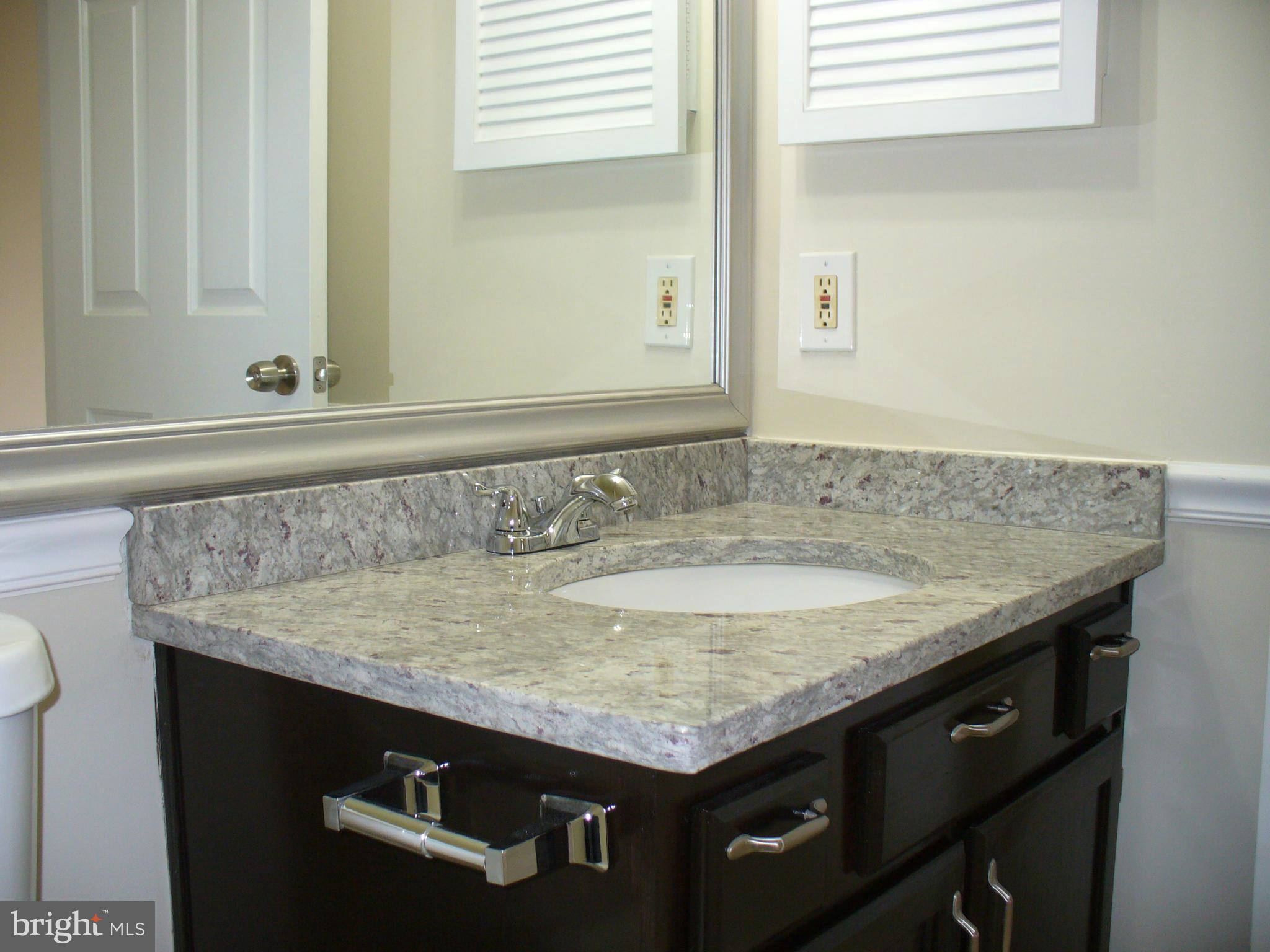 14331 Twig Road Silver Spring, MD 20905 - Photo 18 of 27 a bathroom with a granite countertop sink and a mirror