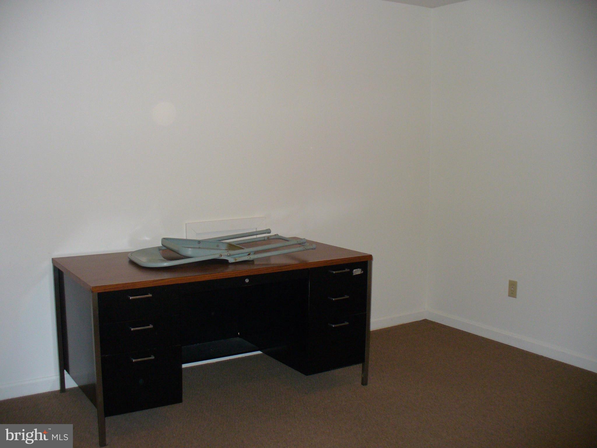 14331 Twig Road Silver Spring, MD 20905 - Photo 24 of 27 a room with a table and a lamp