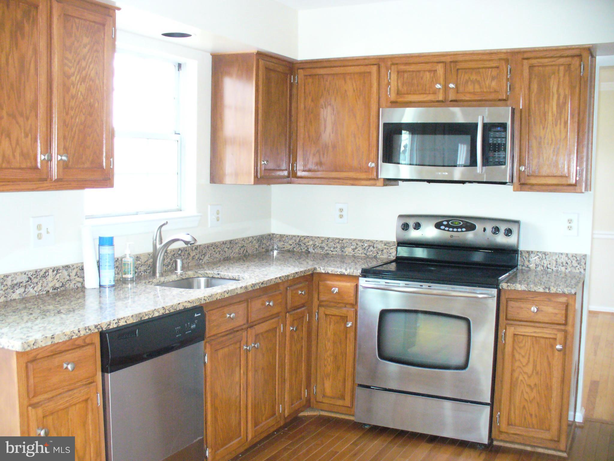 14331 Twig Road Silver Spring, MD 20905 - Photo 6 of 27 a kitchen with granite countertop a sink and a stove