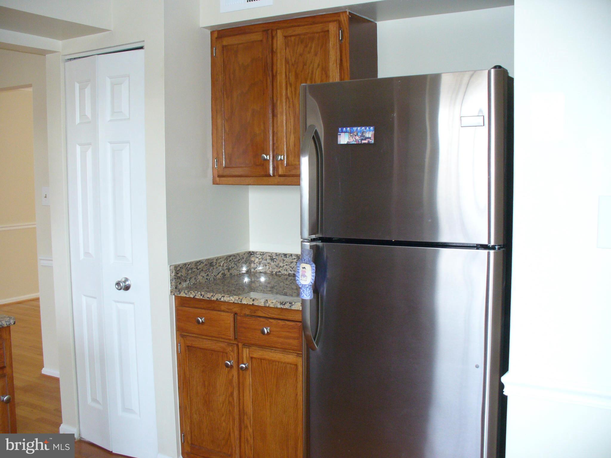 14331 Twig Road Silver Spring, MD 20905 - Photo 7 of 27 a refrigerator freezer sitting in a kitchen