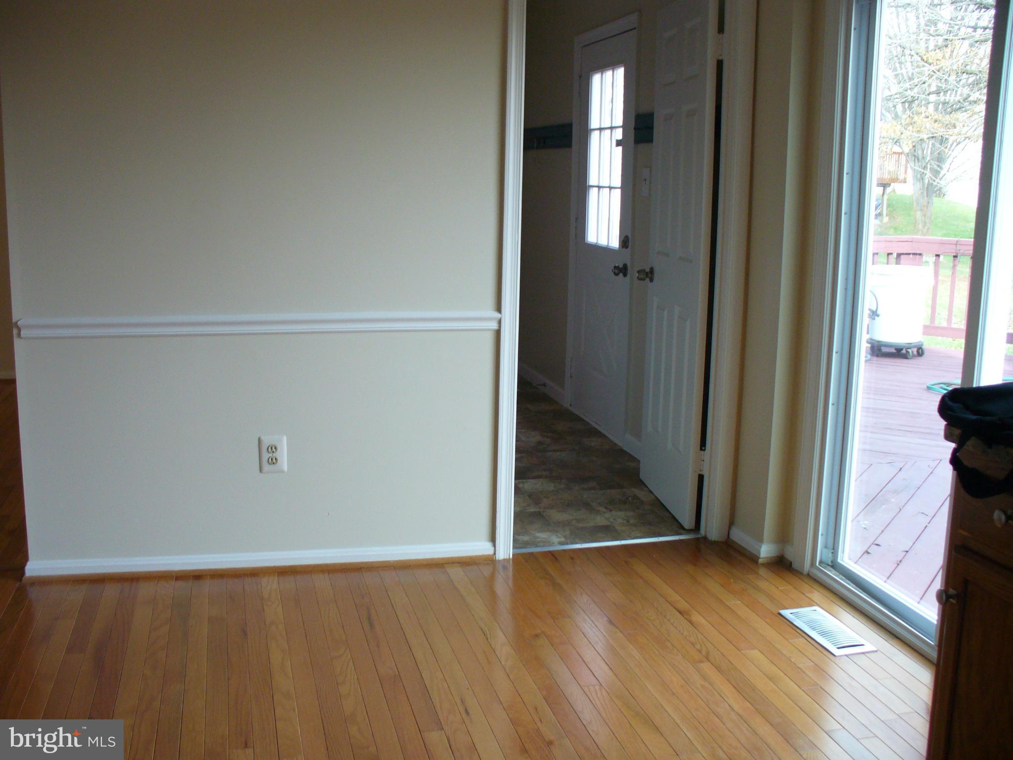 14331 Twig Road Silver Spring, MD 20905 - Photo 8 of 27 an empty room with wooden floor and windows