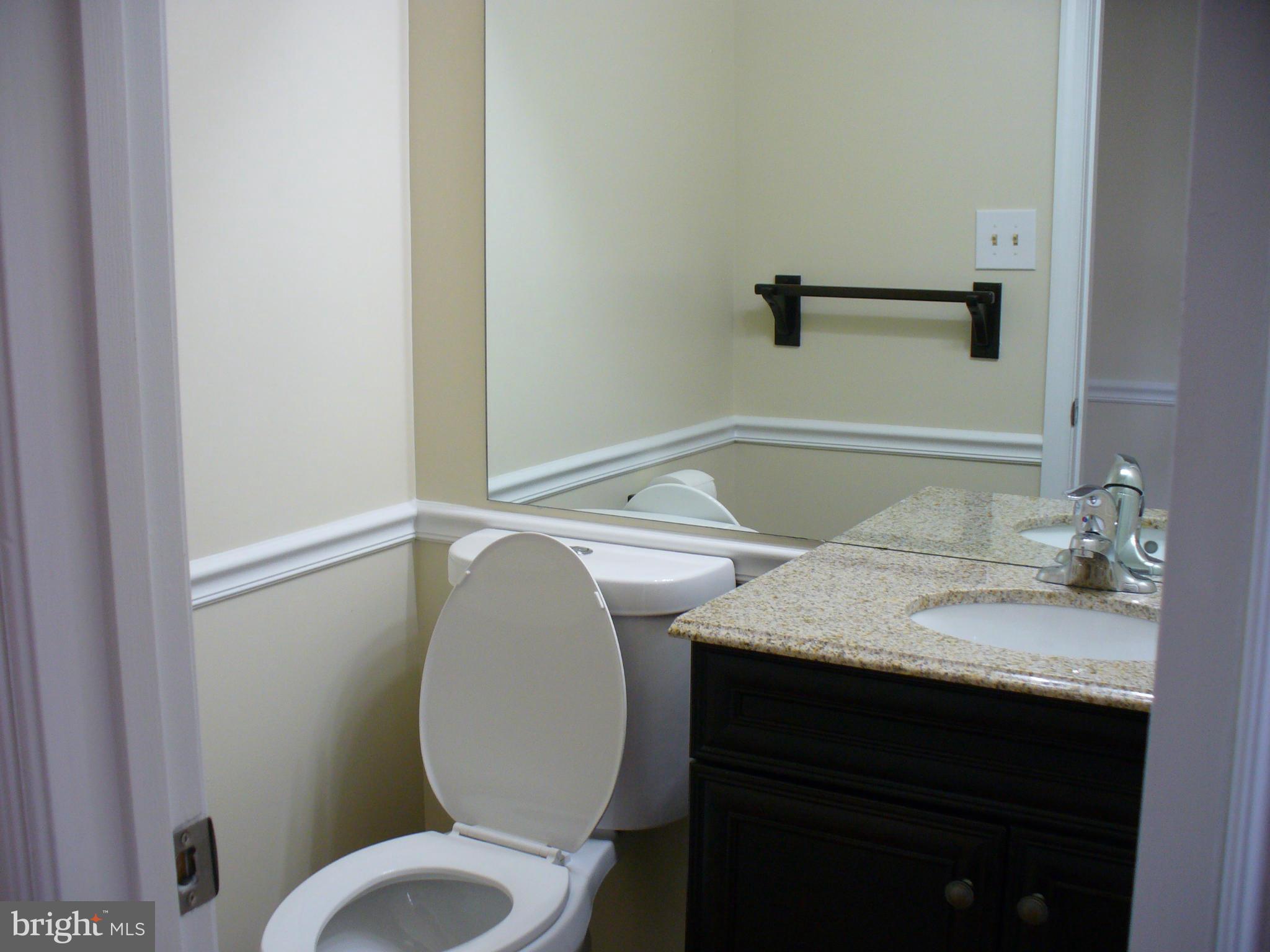 14331 Twig Road Silver Spring, MD 20905 - Photo 10 of 27 a bathroom with a granite countertop sink toilet and mirror