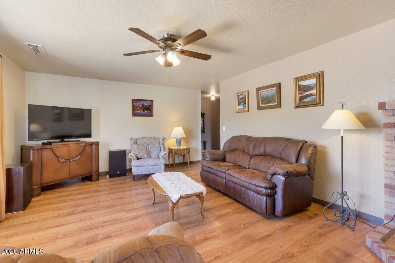 949 Rabbit Run Clarkdale, AZ 86324 - Photo 11 of 46 a living room with furniture and a flat screen tv
