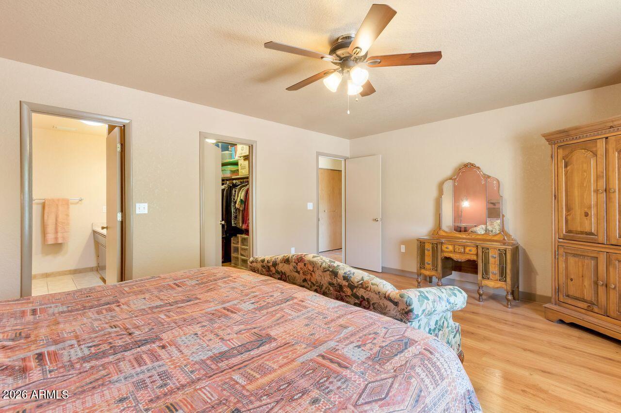 949 Rabbit Run Clarkdale, AZ 86324 - Photo 15 of 46 a bedroom with a bed and a chandelier