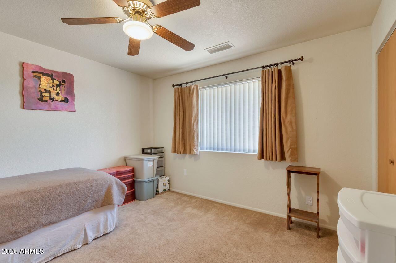 949 Rabbit Run Clarkdale, AZ 86324 - Photo 17 of 46 a bedroom with a bed and a chandelier