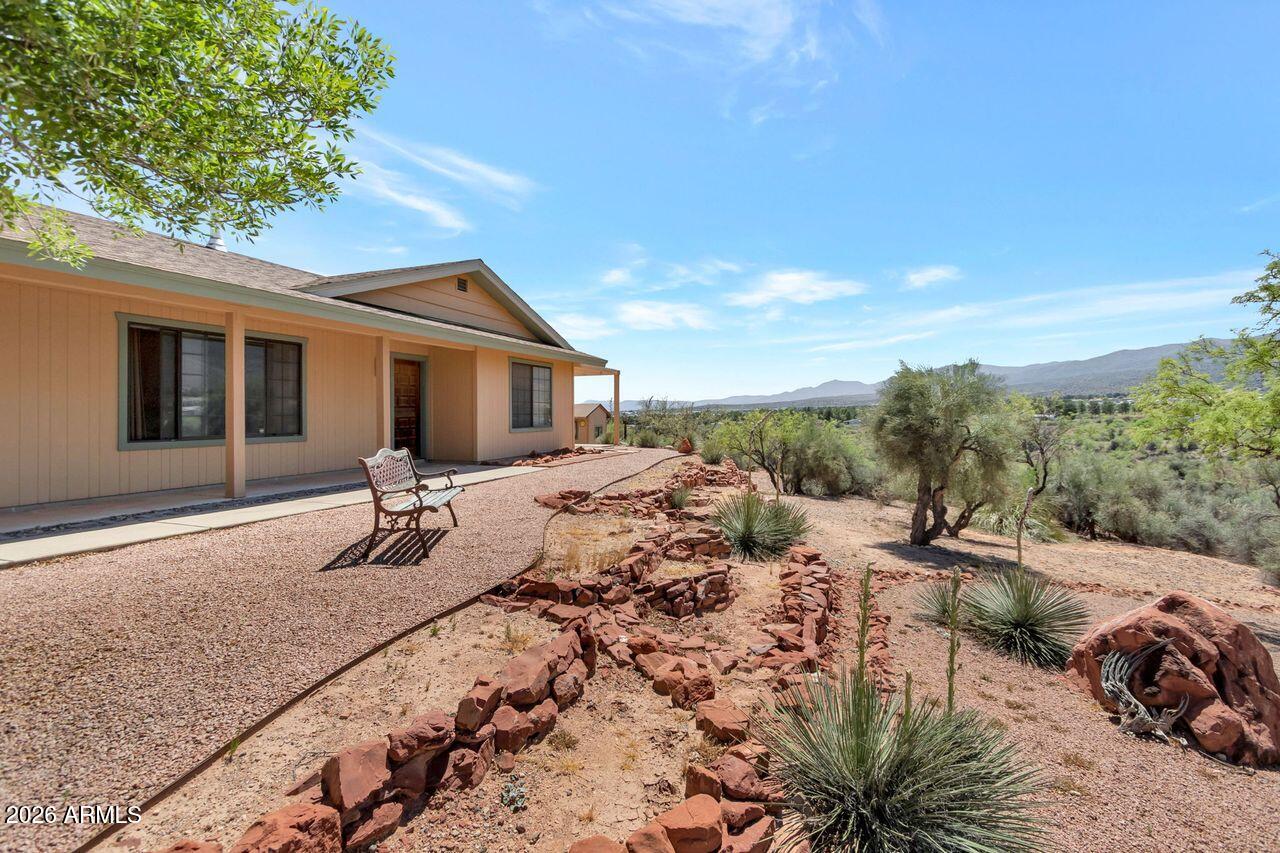 949 Rabbit Run Clarkdale, AZ 86324 - Photo 2 of 46 a view of a house with a backyard and sitting area