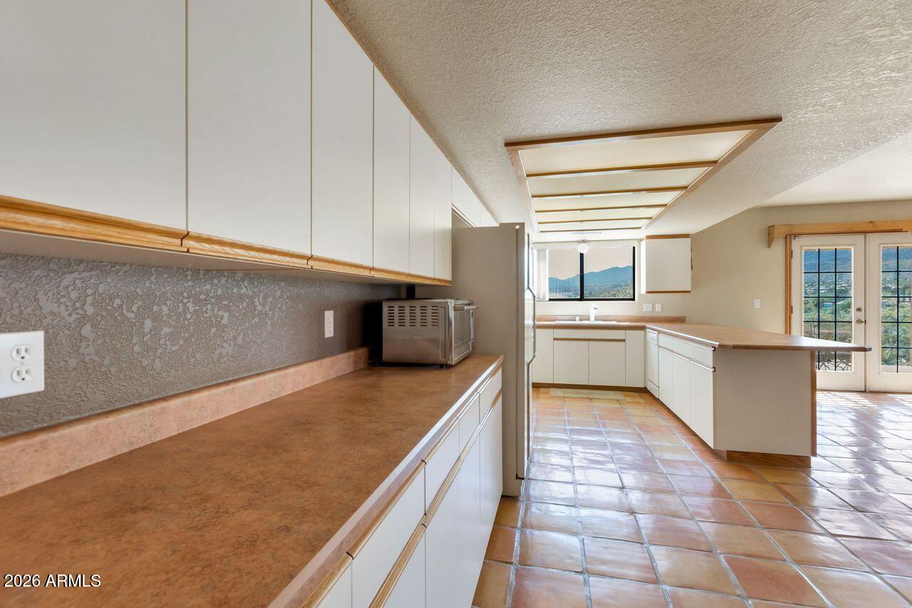 949 Rabbit Run Clarkdale, AZ 86324 - Photo 7 of 46 a kitchen with stainless steel appliances a sink a stove top oven a counter space and cabinets