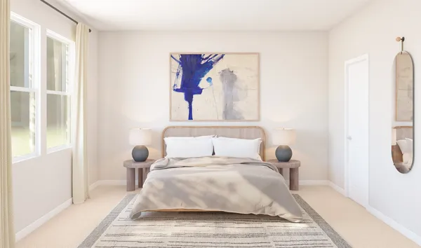 a bedroom with a bed and a painting on the wall