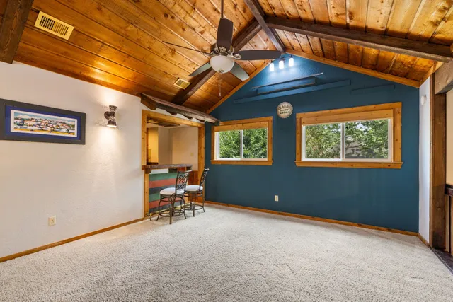 a large kitchen with stainless steel appliances granite countertop a sink and a refrigerator