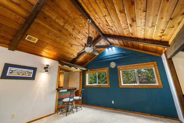 a room with a flat screen tv closet and a dresser