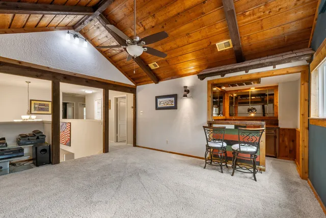 a bathroom with a granite countertop shower a sink and a mirror