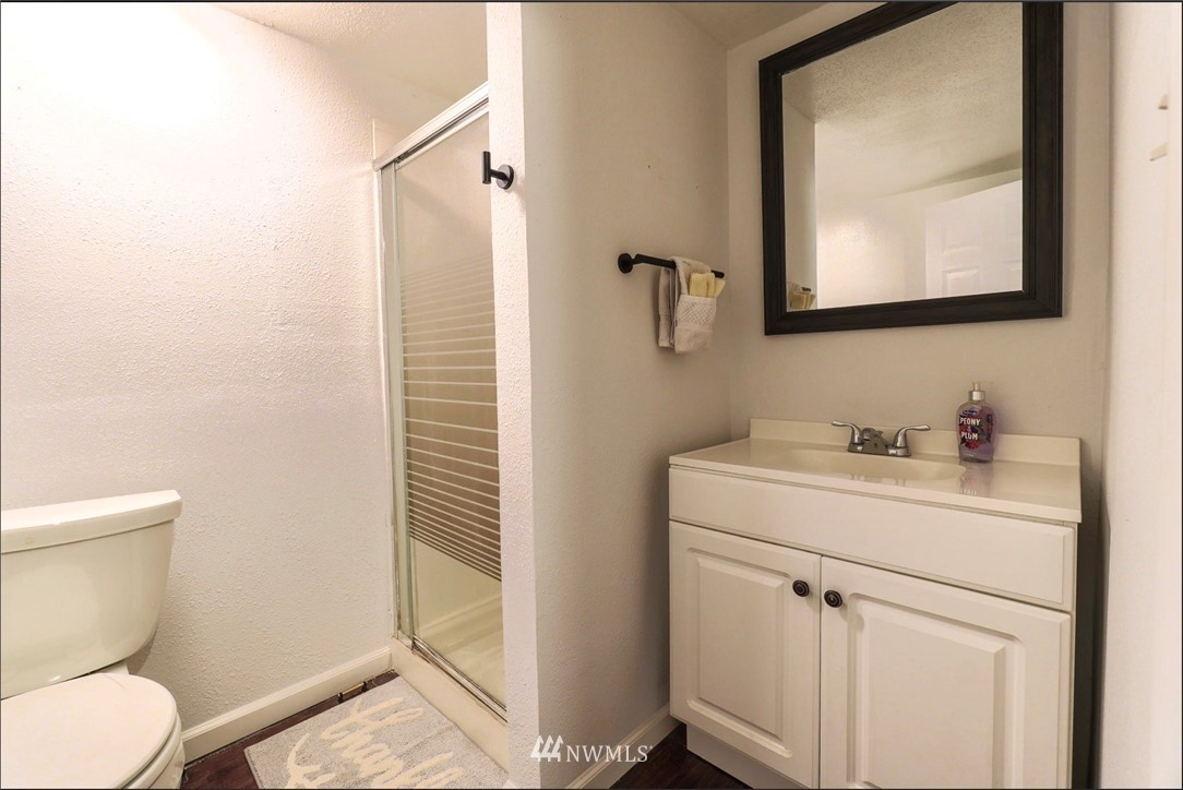 448 Windsor Way Northeast Renton, WA 98056 - Photo 15 of 20 a bathroom with a toilet sink vanity and mirror