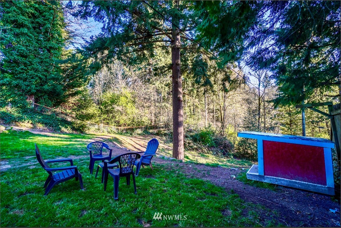 448 Windsor Way Northeast Renton, WA 98056 - Photo 19 of 20 a view of a wooden chairs and fire pit in a yard