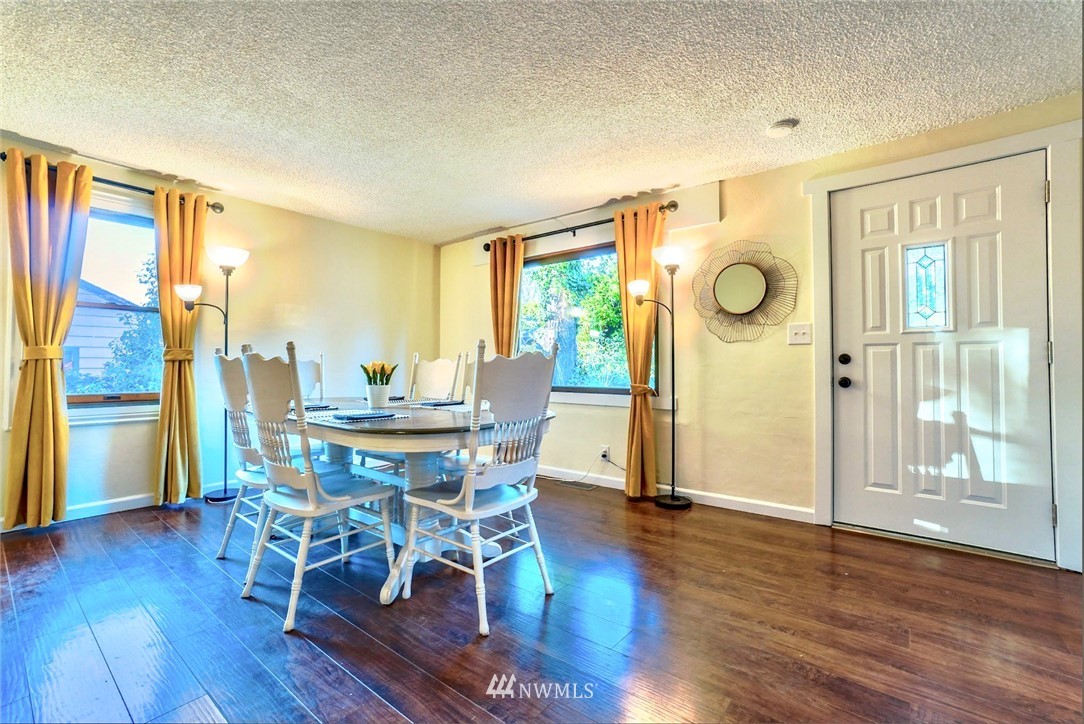 448 Windsor Way Northeast Renton, WA 98056 - Photo 3 of 20 a view of a dining room with furniture and wooden floor