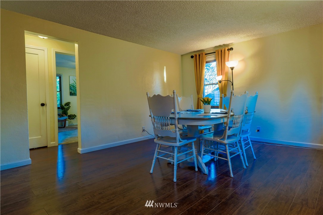 448 Windsor Way Northeast Renton, WA 98056 - Photo 4 of 20 a view of a dining room with furniture and wooden floor