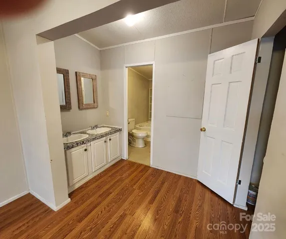 a view of a kitchen cabinets a sink and wooden floor