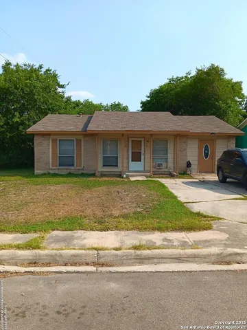 a front view of a house with a garden and plants
