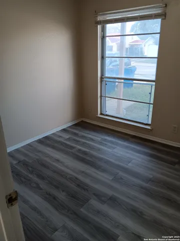 a view of room with wooden floor and window