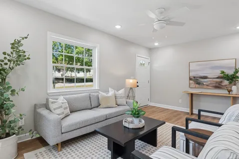 a living room with furniture and wooden floor