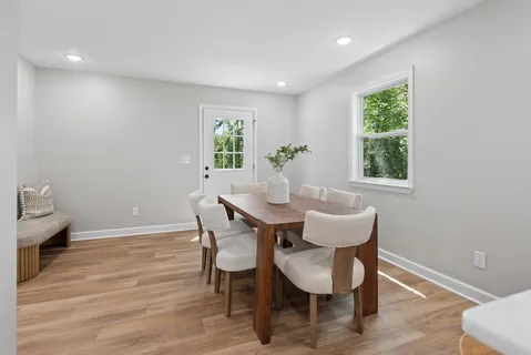 a view of a dining room with furniture and a window