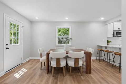 a view of a dining room with furniture window and wooden floor