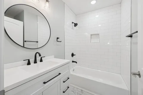 a bathroom with a sink a toilet and a mirror