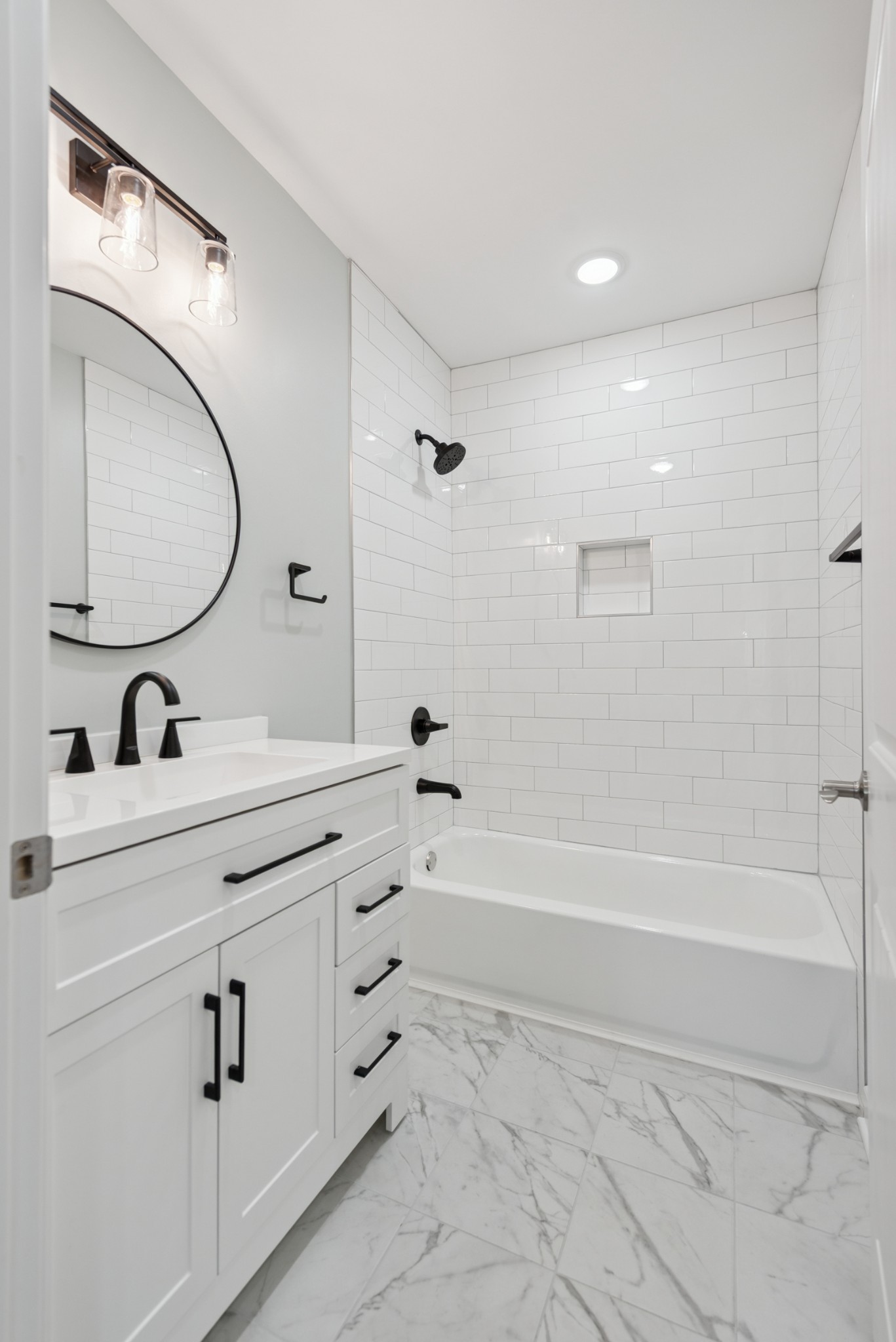 112 Wiley Street Madison, TN 37115 - Photo 22 of 36 a bathroom with a tub sink and mirror