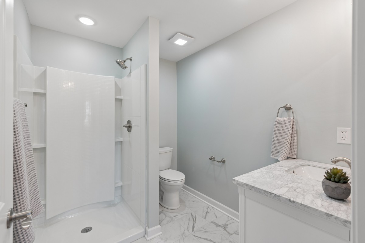 112 Wiley Street Madison, TN 37115 - Photo 28 of 36 a bathroom with a granite countertop sink a toilet and shower