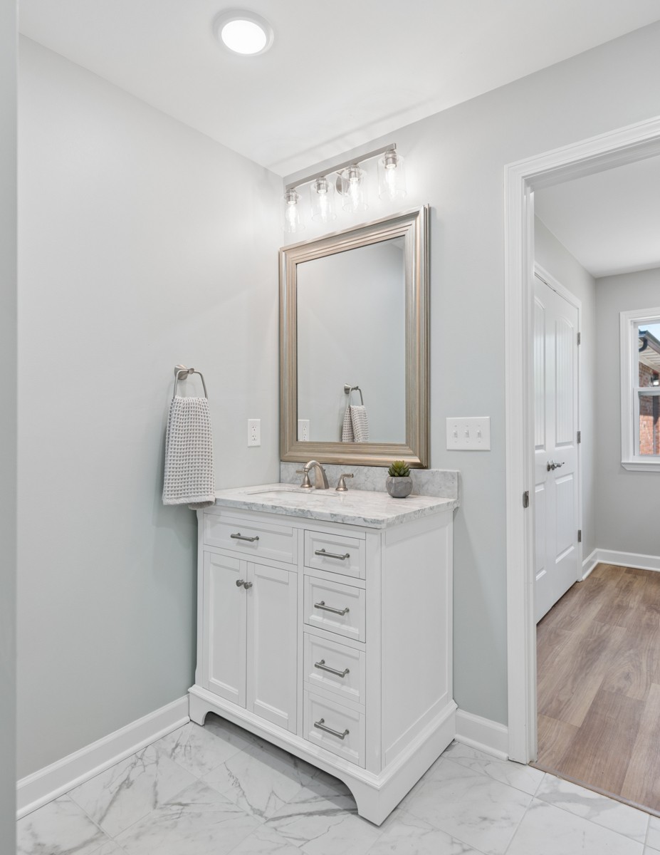 112 Wiley Street Madison, TN 37115 - Photo 29 of 36 a bathroom with a granite countertop sink vanity and mirror