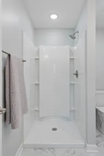 a bathroom with a shower and a glass door