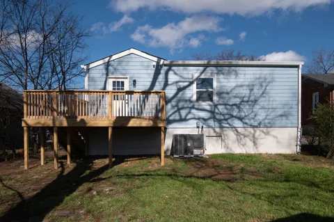 a view of house with a yard