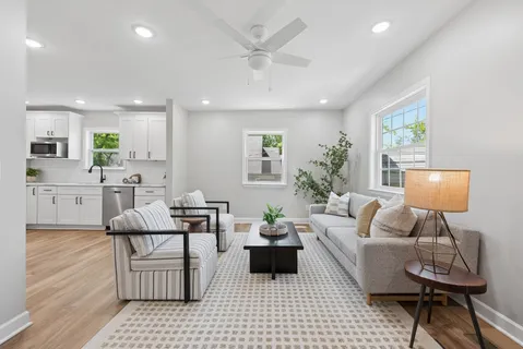 a living room with furniture and a wooden floor