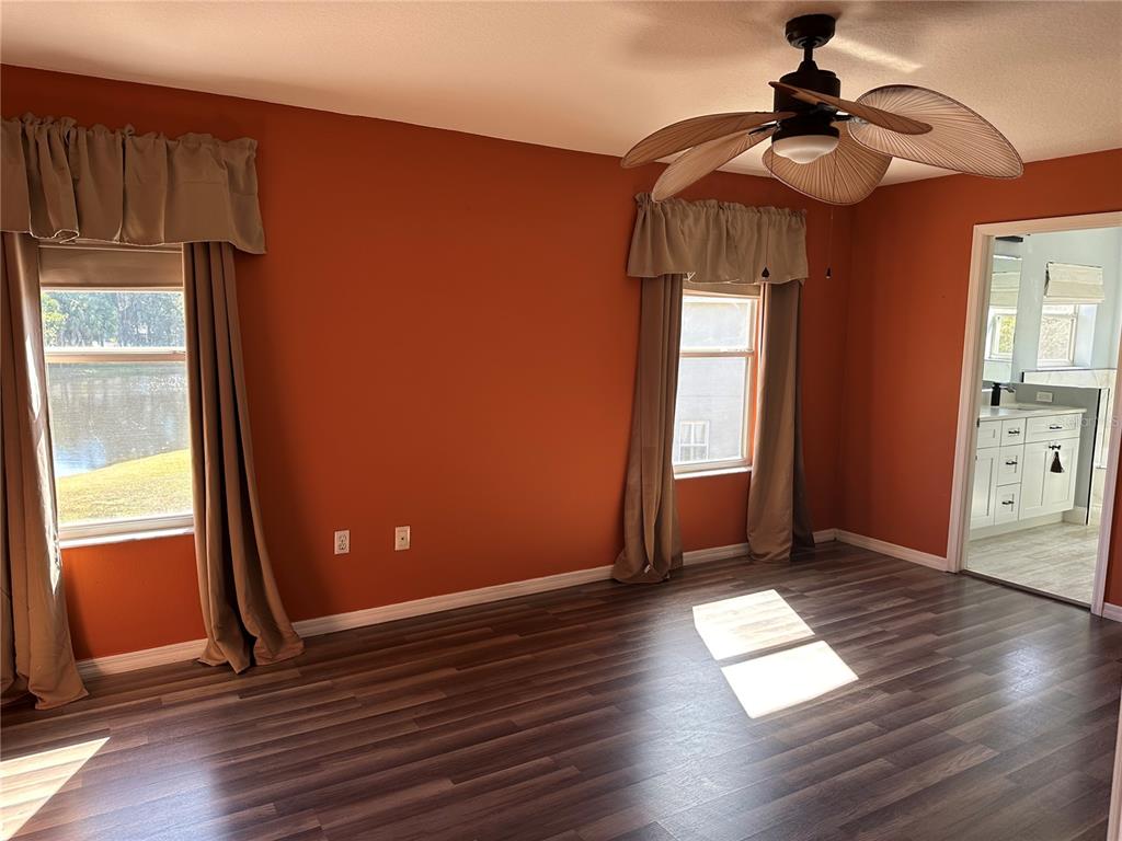 4150 Vanern Way Kissimmee, FL 34746 - Photo 21 of 51 a view of empty room with wooden floor and fan