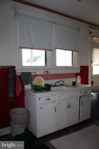 a view of a room with furniture and a table