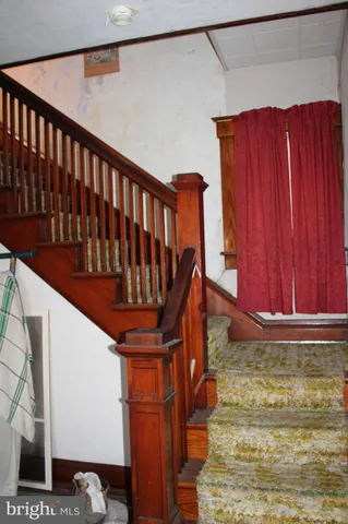 a bedroom with bed and mirror