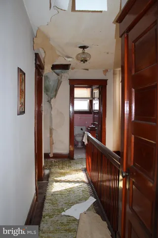 a view of a bedroom with a bed and a mirror