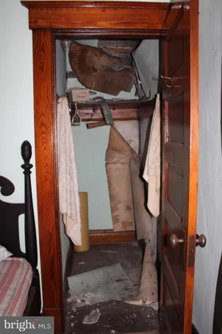 a bedroom with a bed and a mirror